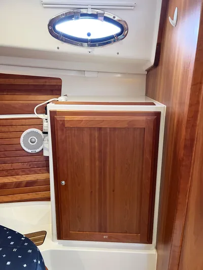 Traveller Yacht Photos Pics 2016 Back Cove 34 interior with wooden cabinet and porthole.