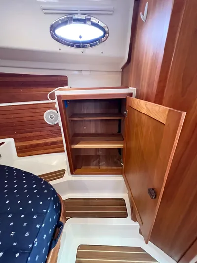 Traveller Yacht Photos Pics 2016 Back Cove 34 interior with open wooden cabinet and seating.