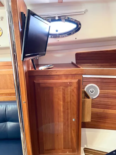 Traveller Yacht Photos Pics 2016 Back Cove 34 interior with wooden cabinetry and mounted TV.