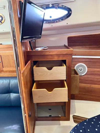 Traveller Yacht Photos Pics 2016 Back Cove 34 interior with wooden drawers and mounted TV.
