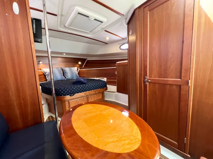 Traveller Yacht Photos Pics Luxurious 2016 Back Cove 34 yacht interior with wood finish and cozy sleeping area.