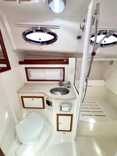 Traveller Yacht Photos Pics 2016 Back Cove 34 yacht bathroom with sink, toilet, and shower.