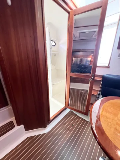 Traveller Yacht Photos Pics 2016 Back Cove 34 interior with wood finish, showing cabin and seating area.
