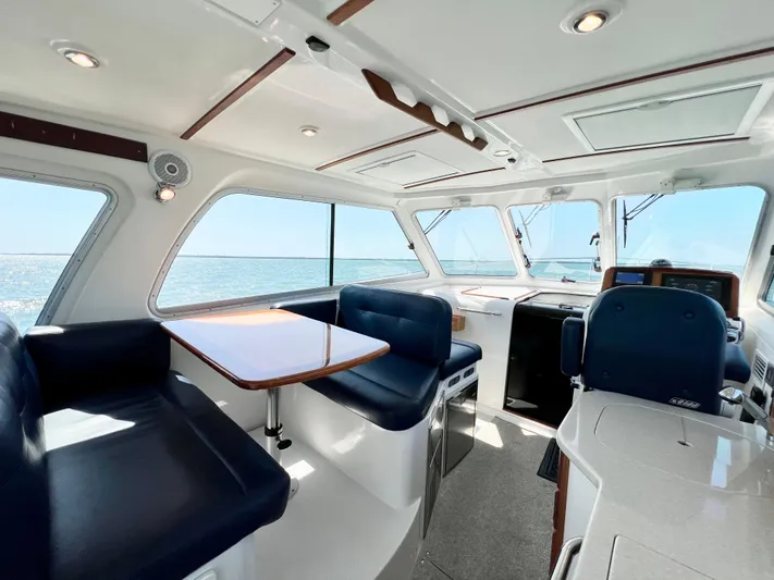 Traveller Yacht Photos Pics Interior of 2016 Back Cove 34 yacht with blue seating and ocean view.