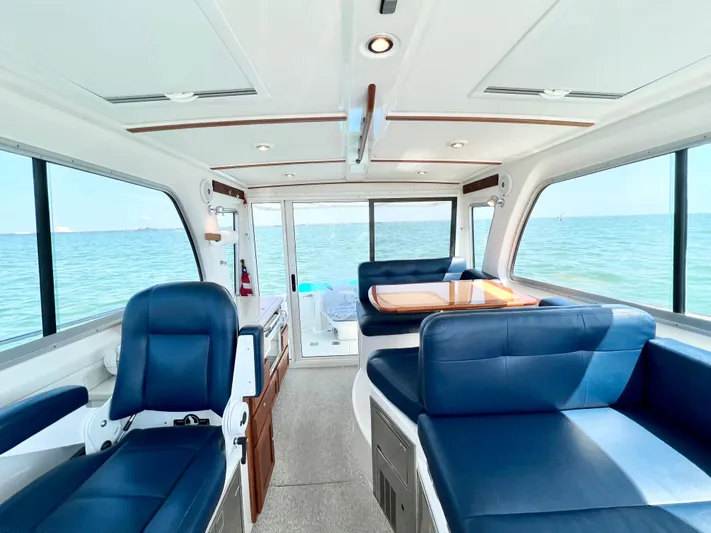 Traveller Yacht Photos Pics Interior of 2016 Back Cove 34 boat with blue seating and ocean view.