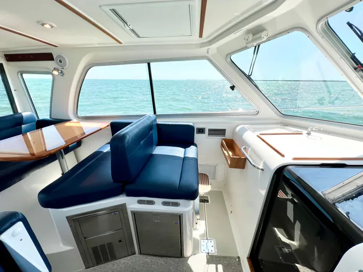 Traveller Yacht Photos Pics Interior of 2016 Back Cove 34 boat with blue seating and ocean view.