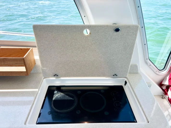 Traveller Yacht Photos Pics 2016 Back Cove 34 yacht interior with stove and ocean view.