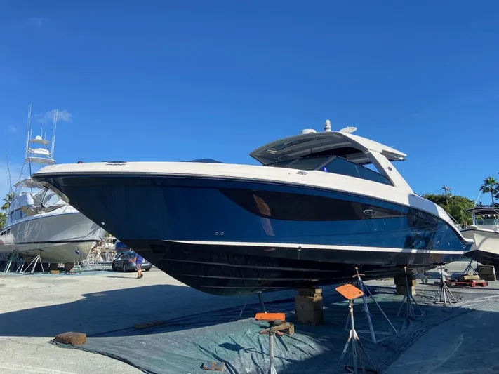 Sobe III Yacht Photos Pics 2019 Sea Ray SLX 400 Outboard boat on stands, blue hull, sunny day.