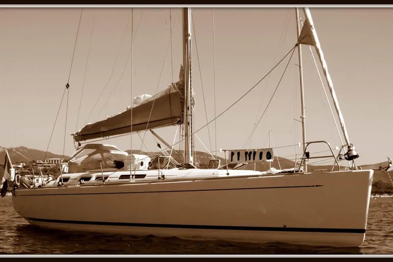  Yacht Photos Pics Sepia-toned image of a 2003 Grand Soleil 45 sailboat on calm waters.