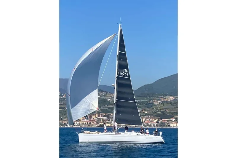  Yacht Photos Pics 2003 Grand Soleil 45 sailboat on open water with scenic coastal backdrop.