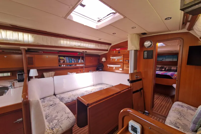  Yacht Photos Pics Interior of 2003 Grand Soleil 45 yacht with cozy seating and wooden finishes.
