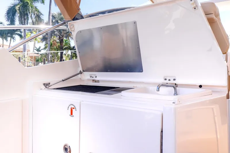 Ocean's Grace Yacht Photos Pics 2016 Pursuit SC 365i yacht outdoor kitchen with grill and sink.