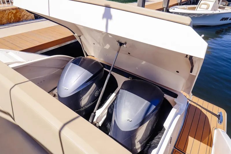 Ocean's Grace Yacht Photos Pics 2016 Pursuit SC 365i boat with open engine compartment, showcasing dual outboard motors.
