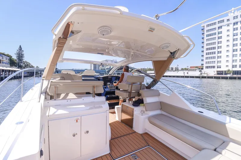 Ocean's Grace Yacht Photos Pics 2016 Pursuit SC 365i yacht interior with seating, helm, and waterfront view.