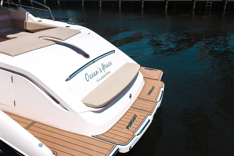 Ocean's Grace Yacht Photos Pics 2016 Pursuit SC 365i yacht with teak deck, docked on calm water.