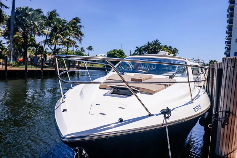 Ocean's Grace Yacht Photos Pics 2016 Pursuit SC 365i boat docked by palm trees and waterway.