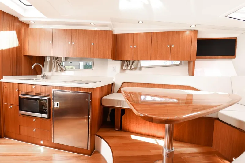 Ocean's Grace Yacht Photos Pics 2016 Pursuit SC 365i yacht interior with modern kitchen and dining area.