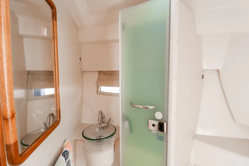 Ocean's Grace Yacht Photos Pics 2016 Pursuit SC 365i boat bathroom with frosted glass door and modern sink.