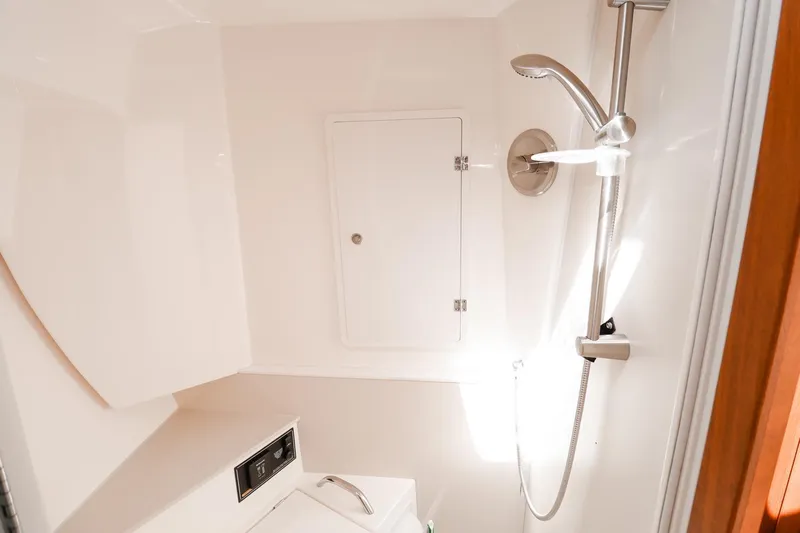 Ocean's Grace Yacht Photos Pics 2016 Pursuit SC 365i boat bathroom with shower and storage compartment.