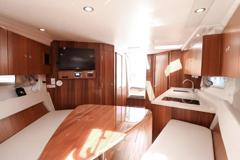 Ocean's Grace Yacht Photos Pics Luxurious interior of 2016 Pursuit SC 365i yacht with wood finish and modern amenities.