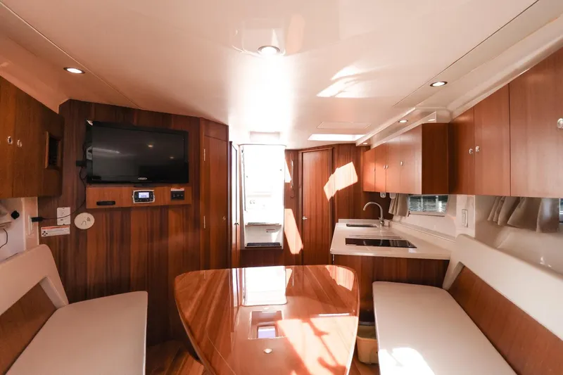 Ocean's Grace Yacht Photos Pics Luxurious interior of a 2016 Pursuit SC 365i yacht with modern amenities and wood finishes.