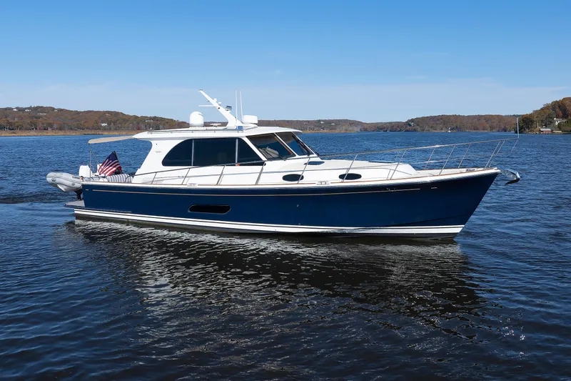 Friendly Persuasion Yacht Photos Pics 2019 Grand Banks 44 Eastbay SX yacht cruising on a calm lake under clear skies.