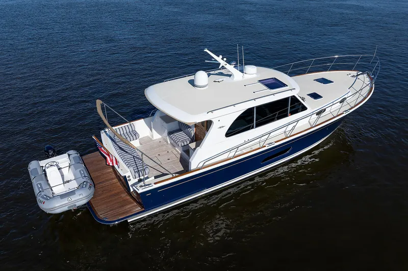 Friendly Persuasion Yacht Photos Pics 2019 Grand Banks 44 Eastbay SX yacht on calm water, featuring sleek design and spacious deck.