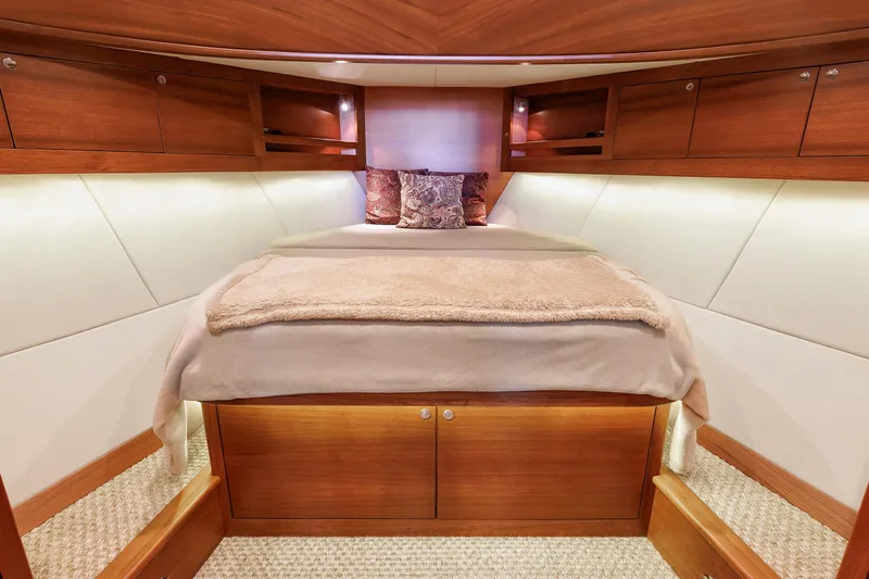 Friendly Persuasion Yacht Photos Pics Luxurious cabin interior of 2019 Grand Banks 44 Eastbay SX yacht, featuring elegant wood finishes.