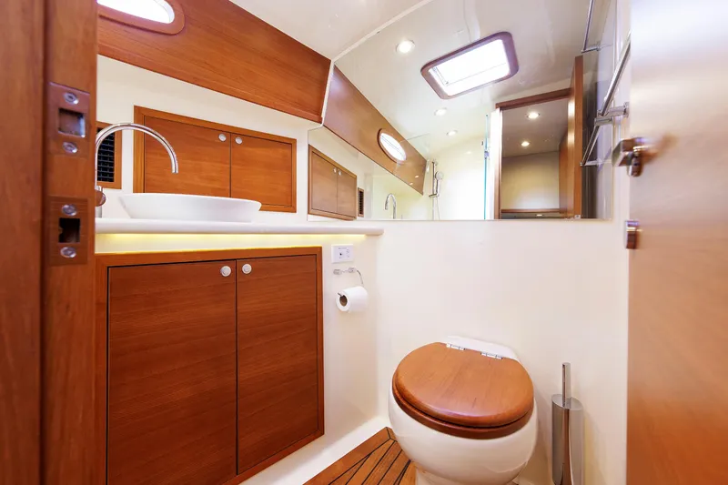 Friendly Persuasion Yacht Photos Pics Luxurious bathroom in 2019 Grand Banks 44 Eastbay SX yacht with wooden cabinetry.