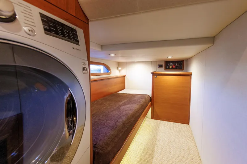 Friendly Persuasion Yacht Photos Pics 2019 Grand Banks 44 Eastbay SX cabin with bed and washer-dryer unit.