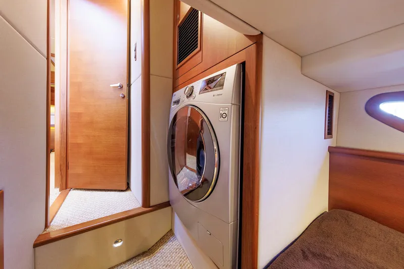 Friendly Persuasion Yacht Photos Pics Laundry area inside 2019 Grand Banks 44 Eastbay SX yacht with modern washer.