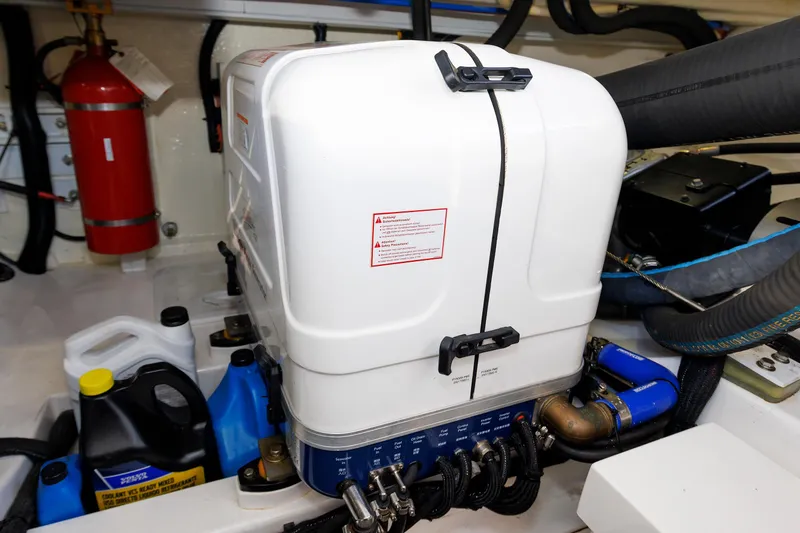 Friendly Persuasion Yacht Photos Pics Engine room of 2019 Grand Banks 44 Eastbay SX with equipment and fire extinguisher.