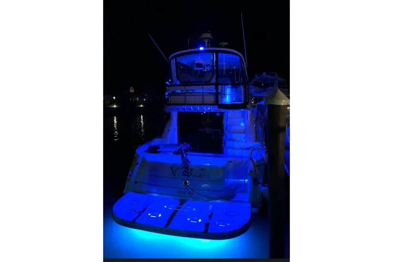 Vtl Yacht Photos Pics 2002 Sea Ray 550 Sedan Bridge yacht illuminated with blue lights at night.