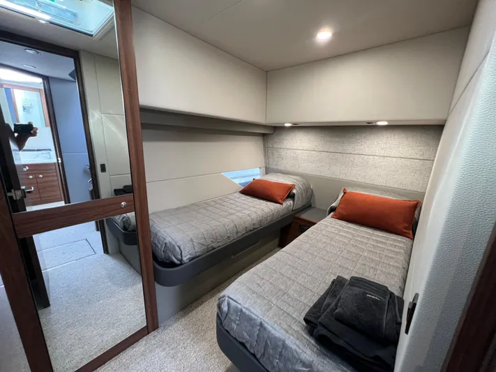  Yacht Photos Pics Luxurious 2023 Maritimo M600 yacht cabin with twin beds and modern decor.