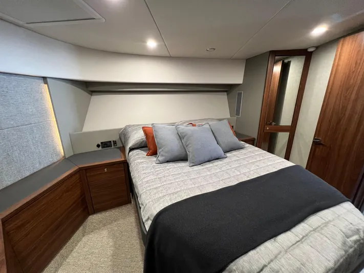  Yacht Photos Pics Luxurious bedroom interior of 2023 Maritimo M600 yacht with modern design and cozy bedding.