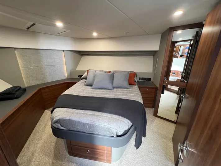  Yacht Photos Pics Luxurious bedroom interior of 2023 Maritimo M600 yacht with modern design and cozy bedding.