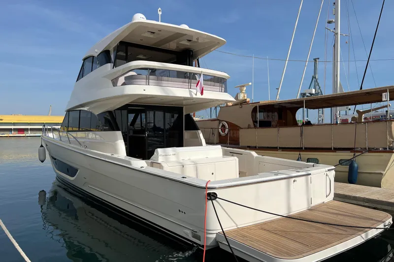  Yacht Photos Pics 2023 Maritimo M600 yacht docked at marina, showcasing sleek design and spacious deck.