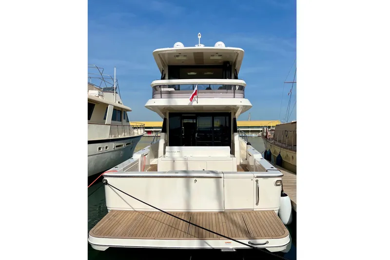  Yacht Photos Pics 2023 Maritimo M600 yacht docked at marina, rear view with spacious deck.