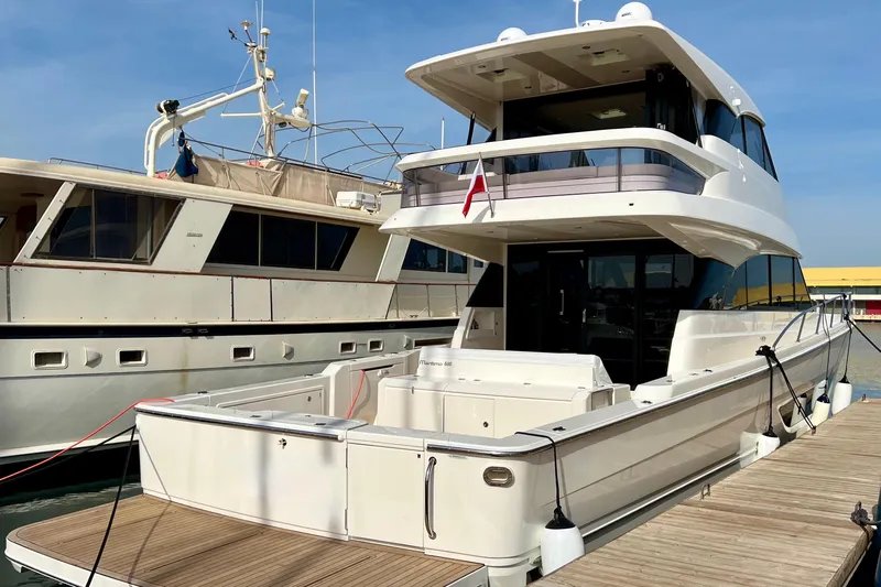  Yacht Photos Pics 2023 Maritimo M600 yacht docked at marina under clear blue sky.