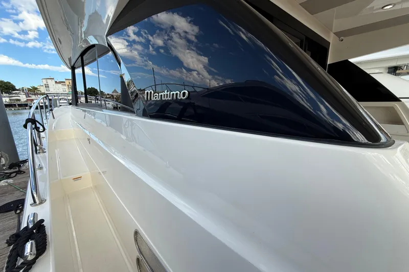  Yacht Photos Pics 2023 Maritimo M600 yacht docked, showcasing sleek design and reflective windows.