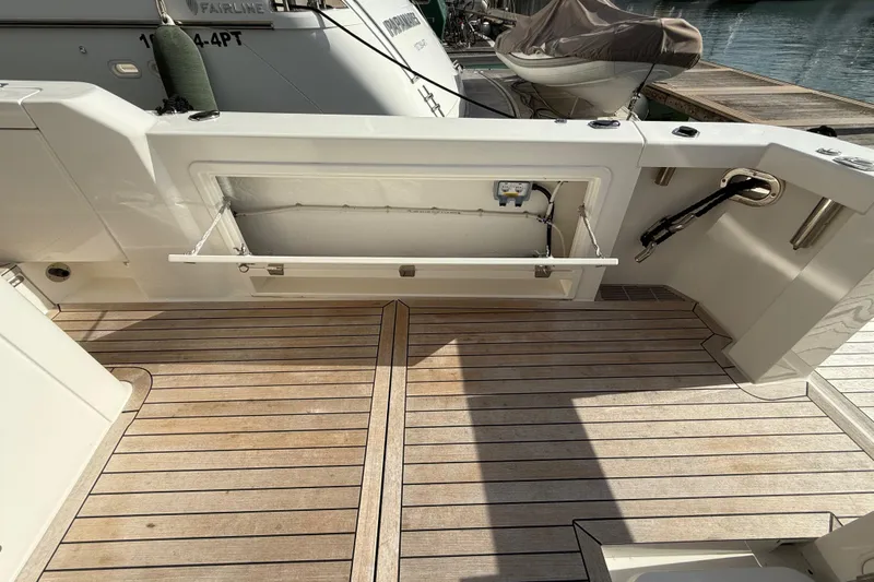  Yacht Photos Pics 2023 Maritimo M600 yacht deck with open storage compartment and teak flooring.