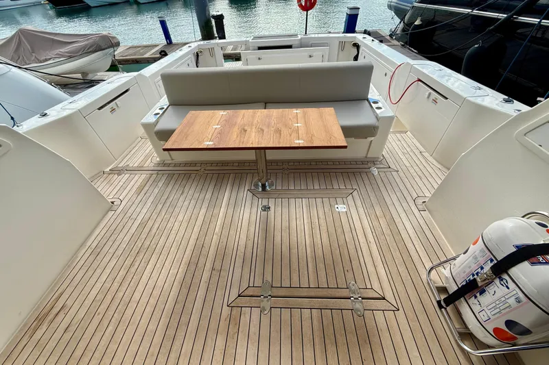  Yacht Photos Pics 2023 Maritimo M600 yacht deck with wooden table and seating area.