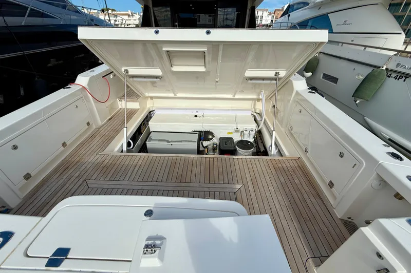  Yacht Photos Pics 2023 Maritimo M600 yacht engine compartment with open hatch and teak flooring.