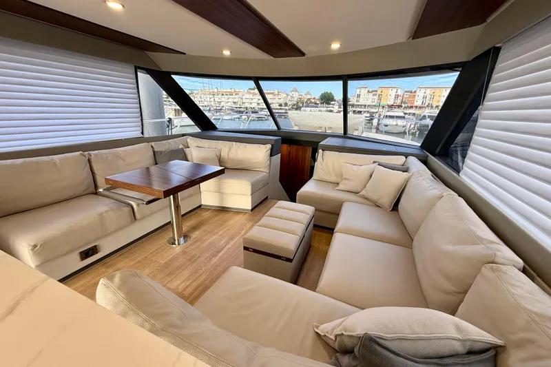  Yacht Photos Pics Luxurious interior of 2023 Maritimo M600 yacht with plush seating and panoramic windows.