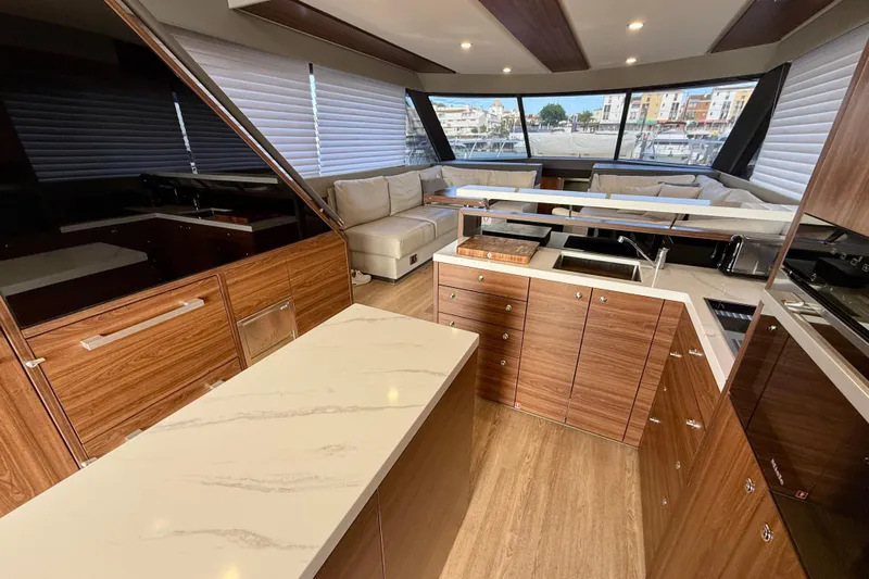 Yacht Photos Pics Luxurious interior of 2023 Maritimo M600 yacht with modern kitchen and spacious seating area.