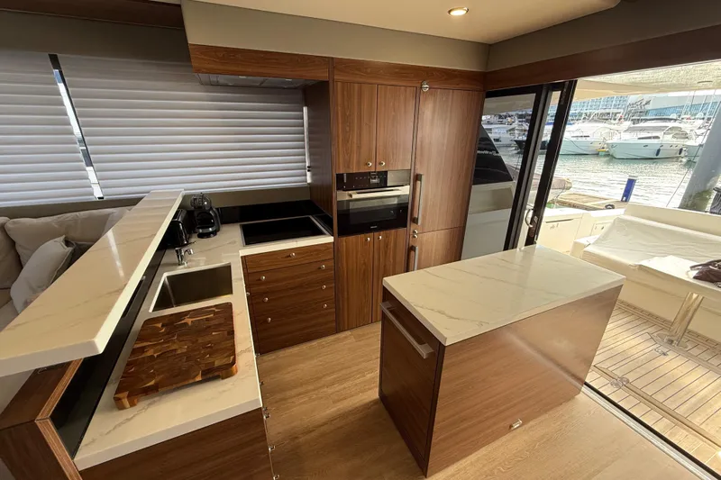  Yacht Photos Pics Luxurious 2023 Maritimo M600 yacht interior with modern kitchen and marina view.