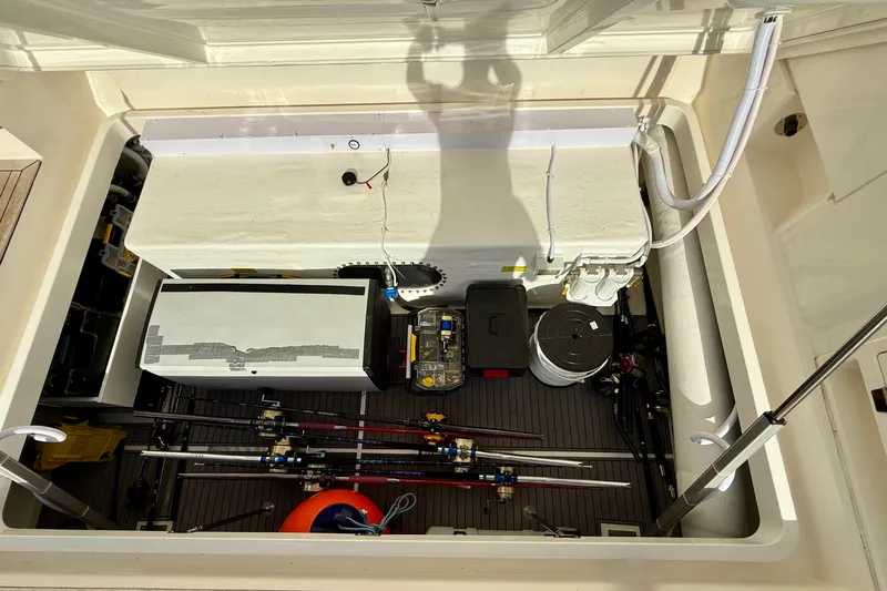  Yacht Photos Pics 2023 Maritimo M600 storage compartment with fishing gear and equipment neatly organized.