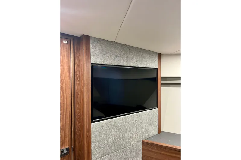  Yacht Photos Pics 2023 Maritimo M600 yacht interior with sleek TV and modern wood paneling.