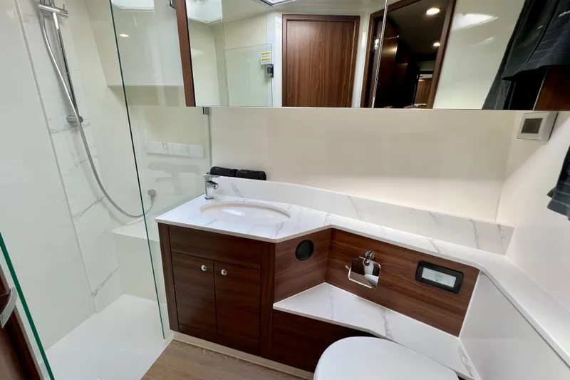  Yacht Photos Pics Luxurious 2023 Maritimo M600 yacht bathroom with modern fixtures and elegant wood accents.