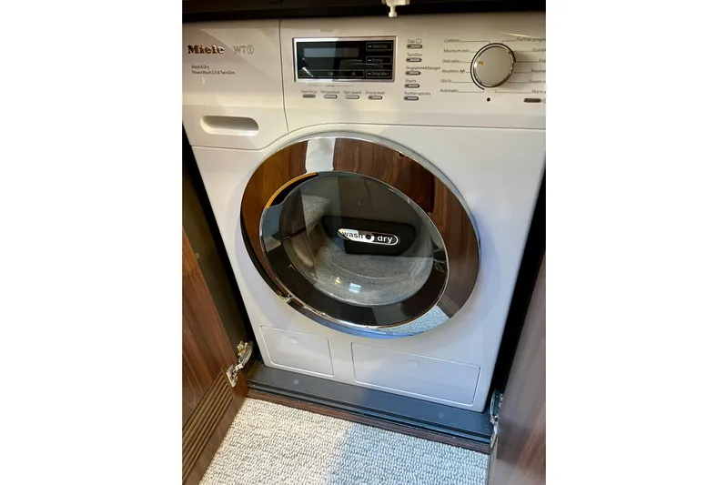  Yacht Photos Pics Miele washer-dryer unit in a 2023 Maritimo M600 yacht interior.